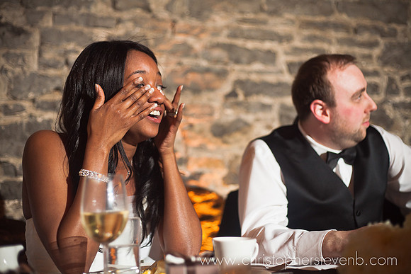 bride crying and wiping tears during wedding speech