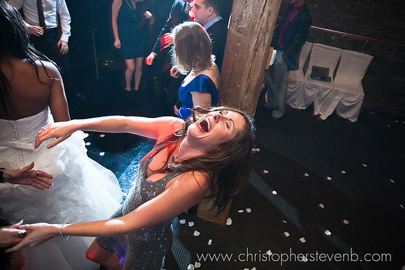 girl dancing and laughing at wedding
