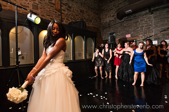 bride preparing to toss bouquet at wedding