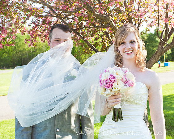 funny wedding photo of groom with bride's veil on his face