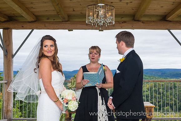 bride looking at guests during Le Belvedere wedding with Gatineaus in the background