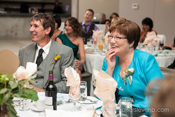 parents of the bride watch speeches during wedding reception