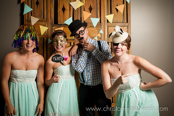 photo booth with bridal party with wig and hat and other disguises
