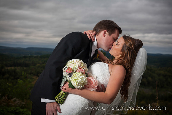 groom dipping bride with beautiful view of gatineaus behind them