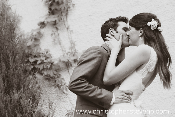 Bride and groom kissing in romantic photo