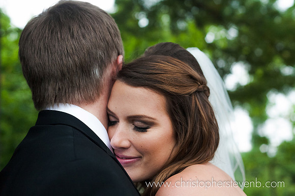 bride dreamily with eyes closed pressing into her husband